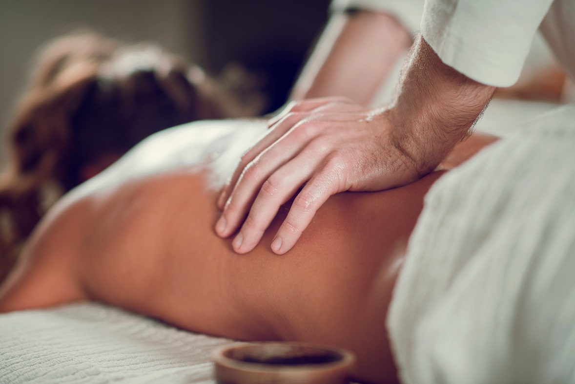 Female Enjoying Relaxing Back Massage In Cosmetology Spa Center